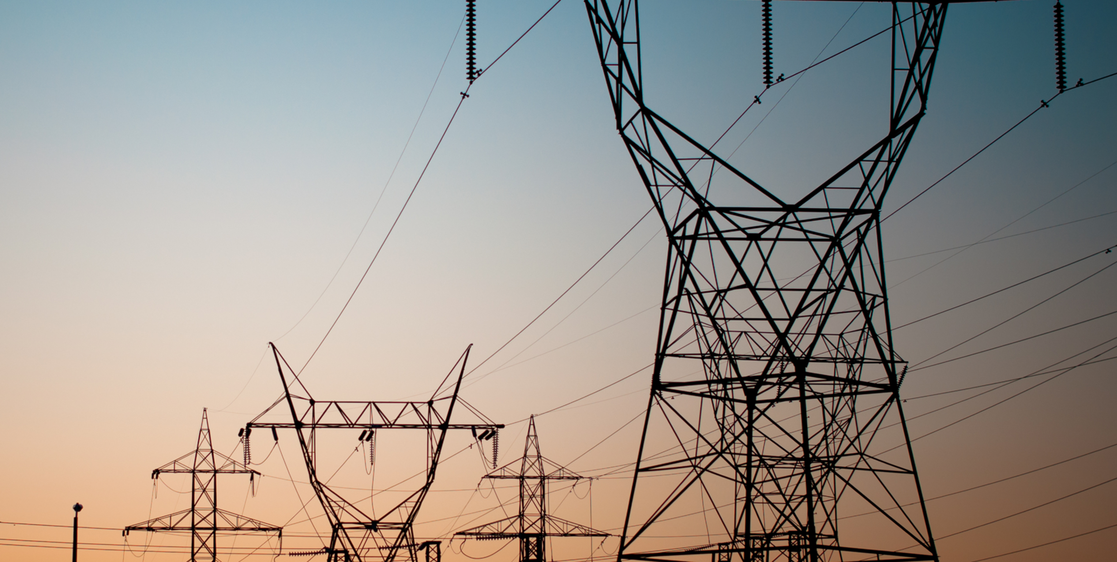 Powerlines silhouetted by a sunset