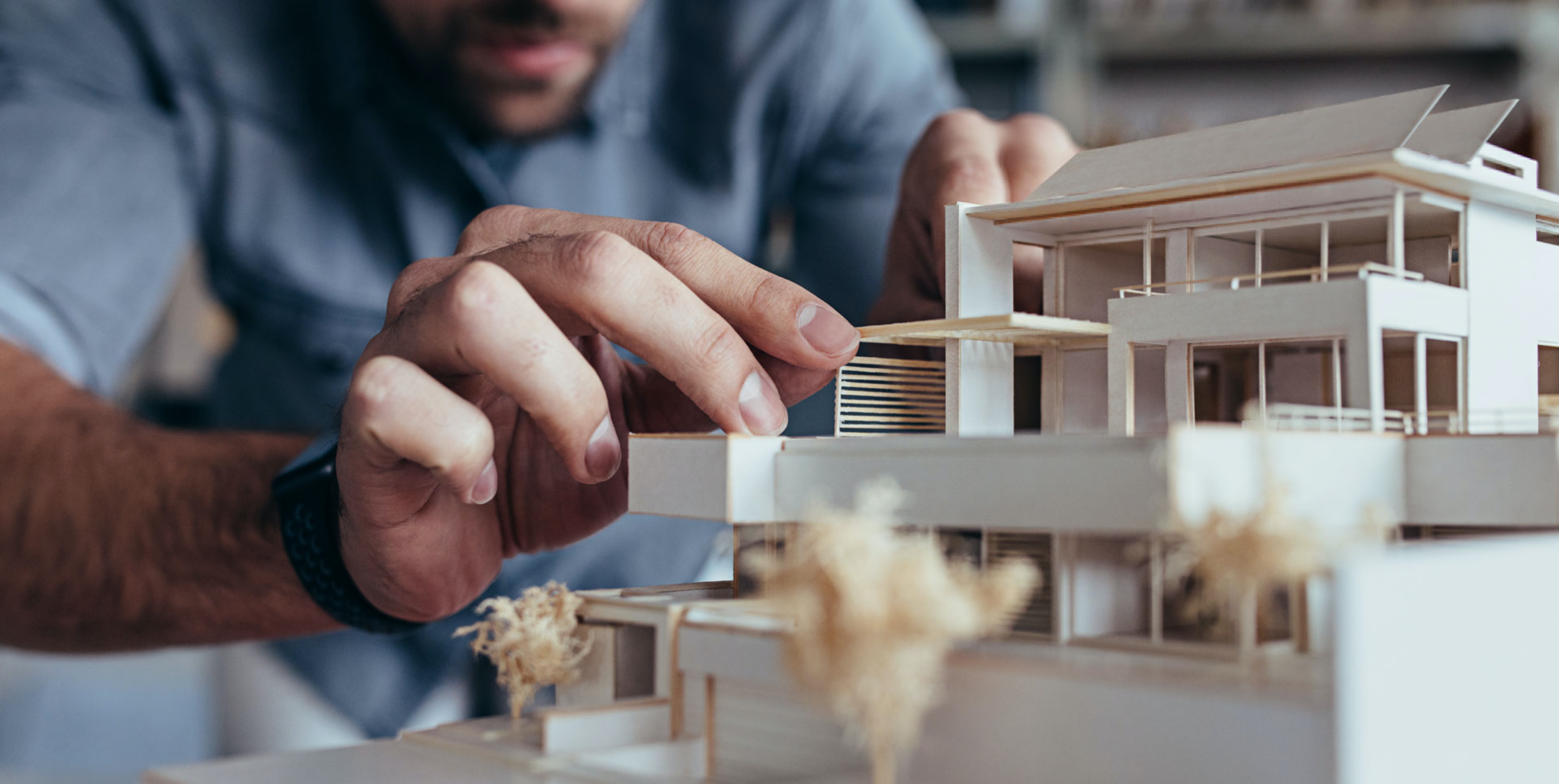 Someone constructing a model house