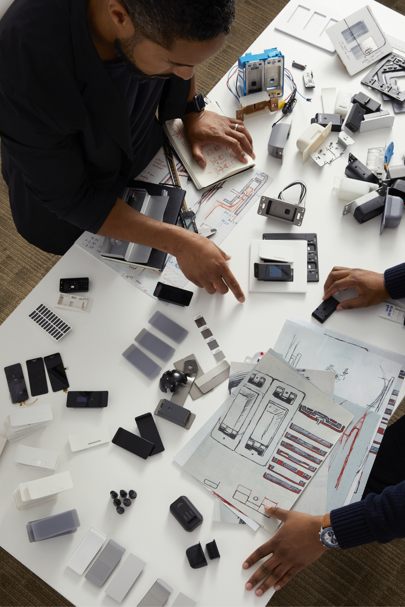 Two engineers working with electronics on a table
